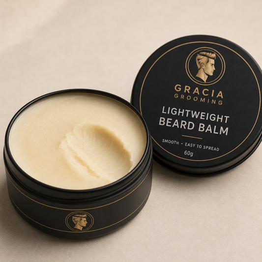 Close-up of smooth warm ivory Gracia Grooming lightweight beard balm in an open black tin